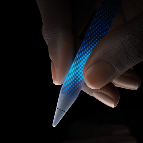 Apple Pencil Pro, side exterior, white colour, thin profile, textured grip, hand holding with tip pointing down illustrating touch-sensitivity and haptic feedback